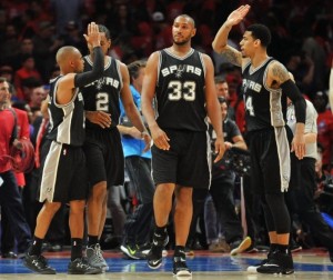 April 22, 2015; Los Angeles, CA, USA; San Antonio Spurs guard Patty Mills (8), forward Kawhi Leonard (2), center Boris Diaw (33) and guard Danny Green (14) celebrate the 111-107 victory against the Los Angeles Clippers following game two of the first round of the NBA Playoffs. at Staples Center. Mandatory Credit: Gary A. Vasquez-USA TODAY Sports