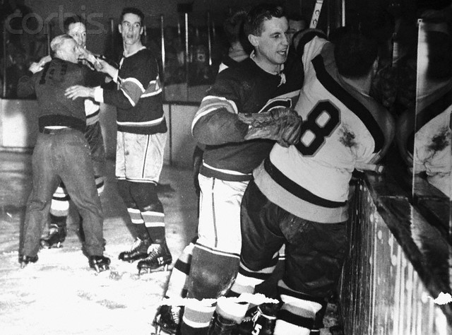 16 Mar 1955, Boston, Massachusetts, USA --- Photo shows a corner of the battlefield in Boston Garden during the bloody third period of the game between the Montreal Canadiens and the Boston Bruins last Sunday night. Maurice Richard, Canadiens' scoring star, flipped when he got a head cut from the stick of the Boston's Hal Laycoe. In the subsequent melee, Laycoe was hurt and linesman Cliff Thompson got banged on the head. In this scene, linesman Sam Babcock and Canadiens' Bert Olmstead are holding back Laycoe (rear) at left. At right, Canadiens' Bellueau is restraining Boston's Fleming Mackell (8). Concealed by the two wrestlers is Maurice Richard. --- Image by © Bettmann/CORBIS