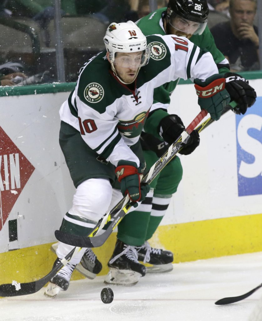 Minnesota Wild center Jordan Schroeder (10) takes control of the puck against Dallas Stars defenseman Stephen Johns (28) during the second period in Game 5 of a first-round NHL hockey Stanley Cup playoff series, Friday, April 22, 2016, in Dallas. (AP Photo/LM Otero)