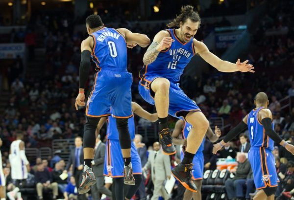 Mar 18, 2016; Philadelphia, PA, USA; Oklahoma City Thunder guard Russell Westbrook (0) celebrates with center Steven Adams (12) after his three pointer against the Philadelphia 76ers during the fourth quarter at Wells Fargo Center. The Oklahoma City Thunder won 111-97.Mandatory Credit: Bill Streicher-USA TODAY Sports